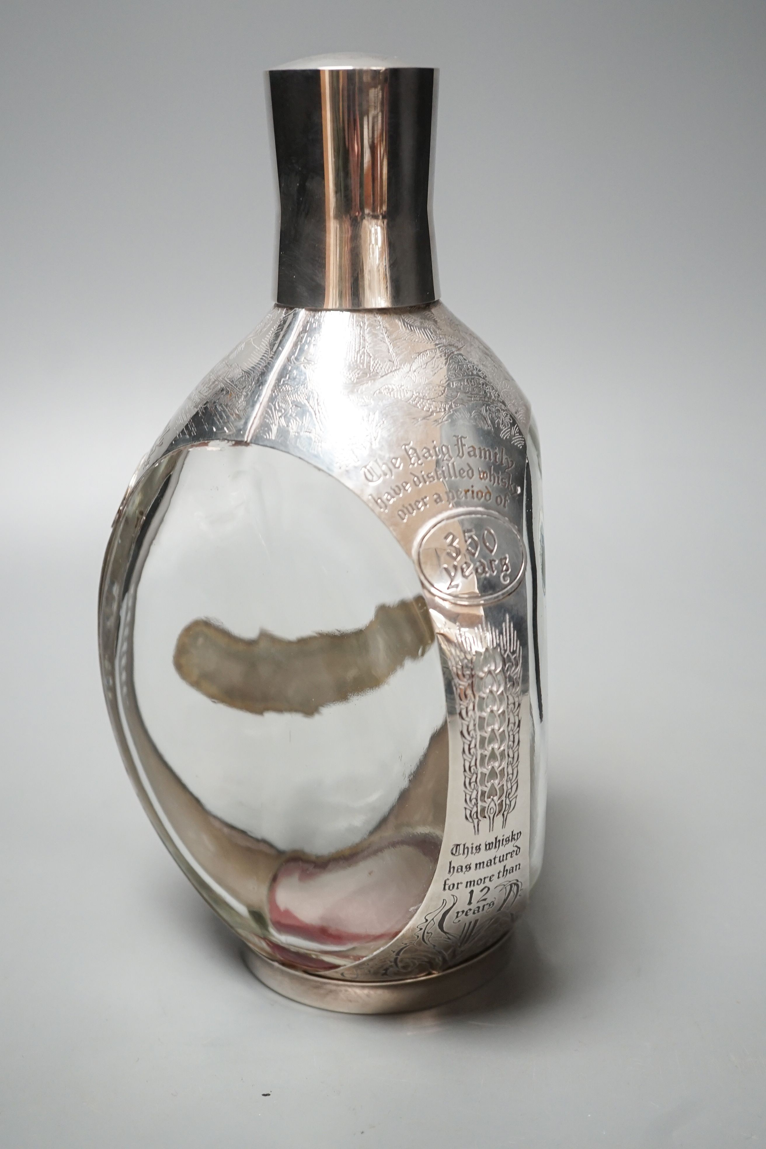 A modern engraved silver mounted glass commemorative Haig Whisky decanter, London, 1977, 22.7cm.